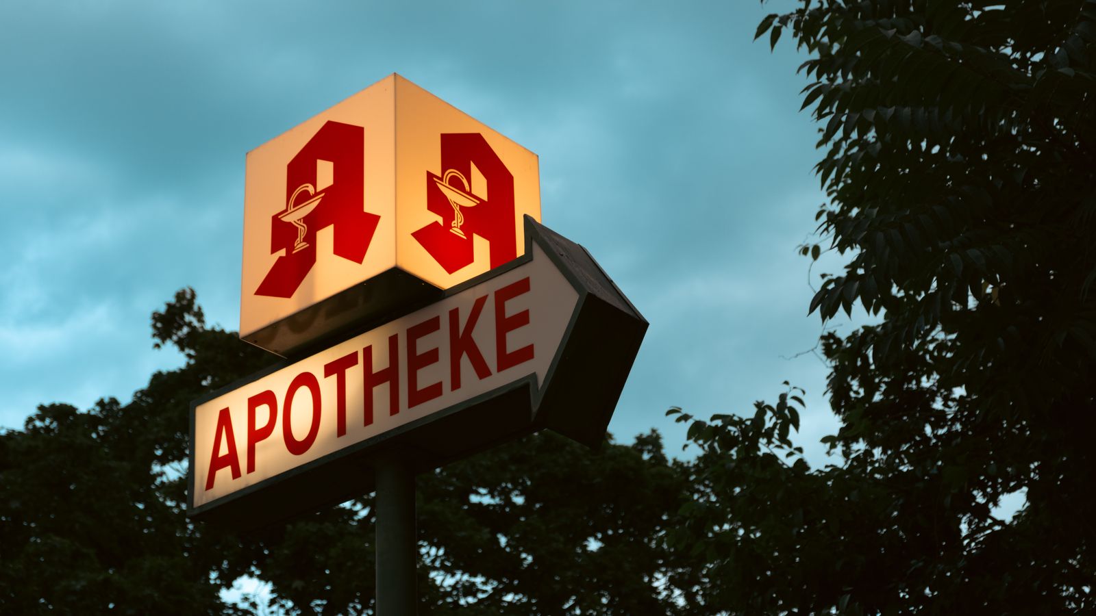 A pharmacy sign at dusk