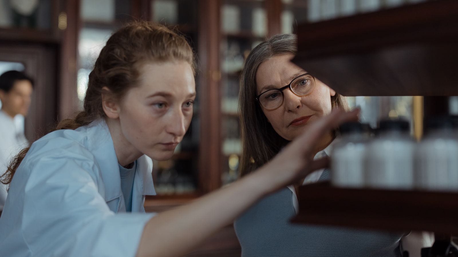 Two pharmacy staff reviewing medicines together