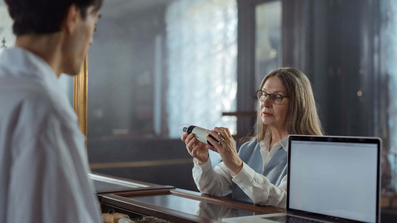 A pharmacist reviewing figures at the dispensary