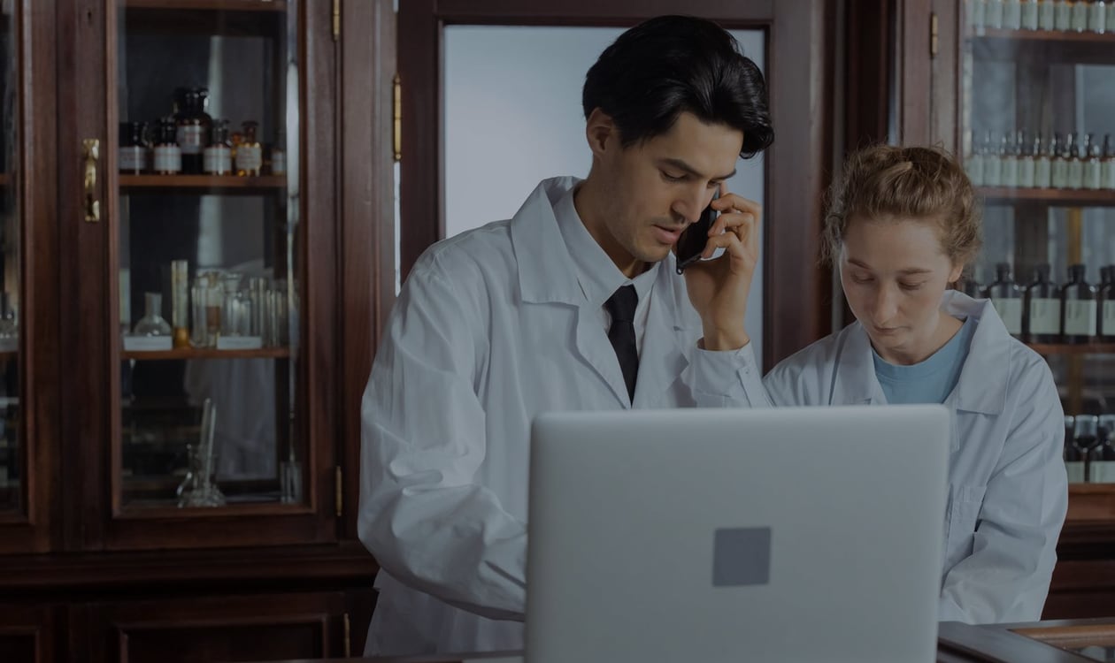 Pharmacist using a telephone at a community pharmacy