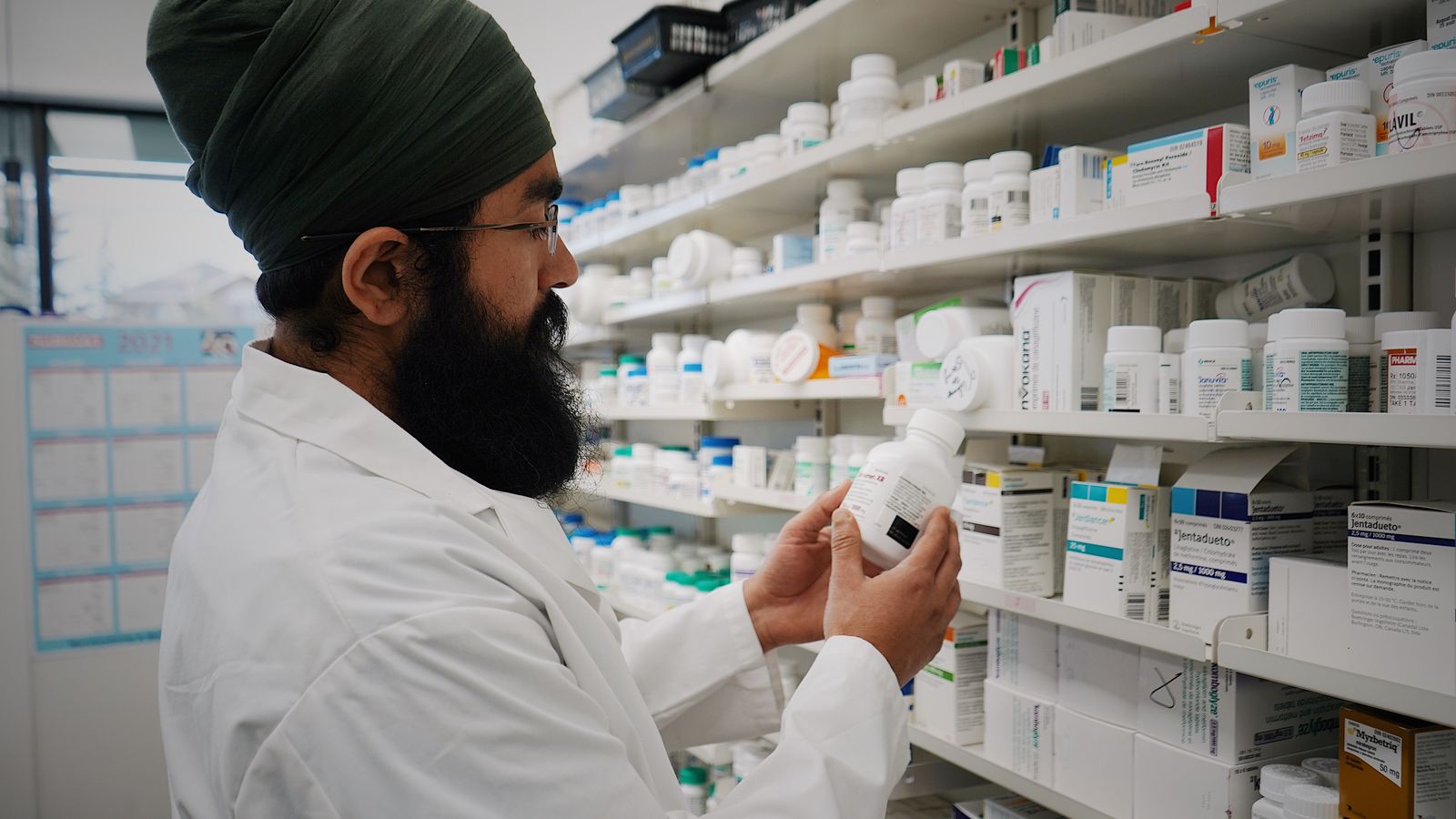 Boxes of medicine arranged on a pharmacy shelf