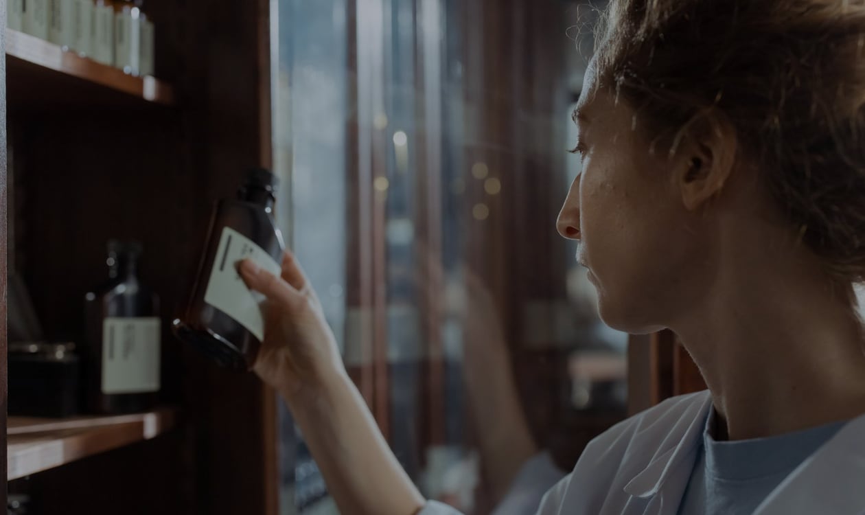 Pharmacist checking medicine stock before placing it on shelves