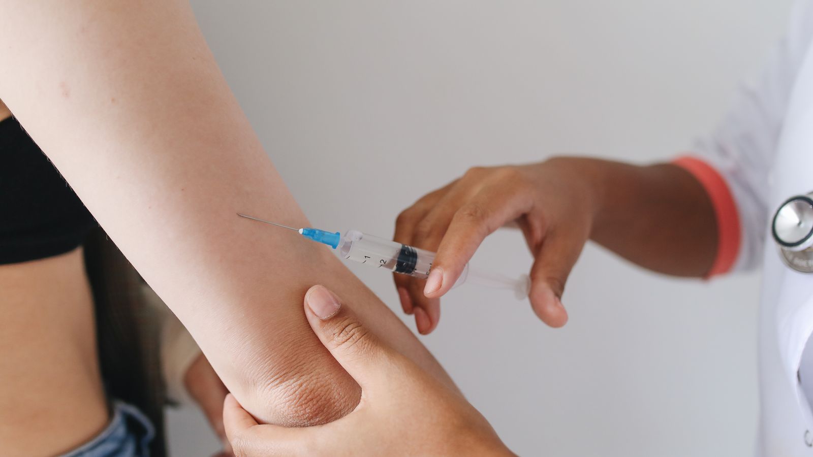 Vaccine being administered into a patient's upper arm